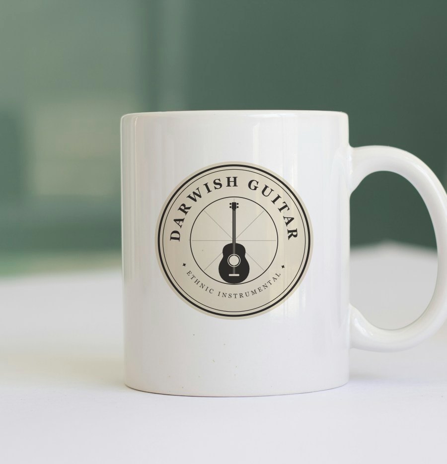 White ceramic mug with the Darwish Guitar emblem